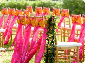 Spice up your wedding day with Chivari Chairs and Hot Pink and Orange Sashes